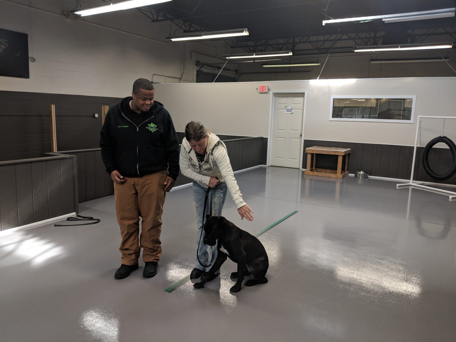 AlphA and Omega trainer coaching an owner during hands-on dog training